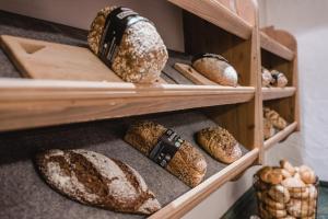 a bunch of loaves of bread on shelves in a bakery at Hotel Oberforsthof in Sankt Johann im Pongau