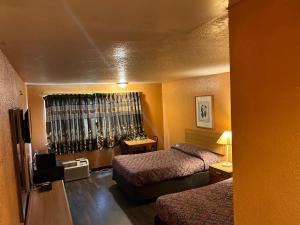 Hillcrist Motel في Aurora: غرفه فندقيه سريرين وتلفزيون