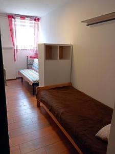 a small room with a bed and a window at Studio apartment Novi Sad in Novi Sad
