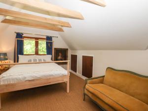 a bedroom with a bed and a couch at Six Acres House in Rye