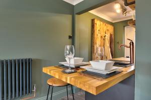 a dining room with a table with glasses and a radiator at Annex by the Sea in Lancing