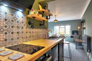 a kitchen with a counter and a stove top oven at Annex by the Sea in Lancing