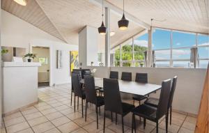 a dining room with a table and chairs at 3 Bedroom Nice Home In Sjølund in Sjølund
