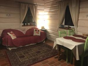 a living room with a couch and a table at Buczynowe Chaty in Wysowa-Zdrój