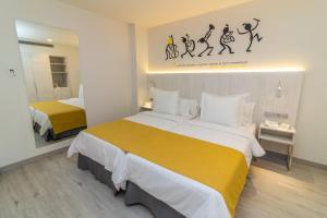 a hotel room with two beds and a mirror at Lemon & Soul Las Palmas in Las Palmas de Gran Canaria