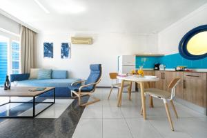 a living room with a blue couch and a table at Labranda El Dorado in Puerto del Carmen