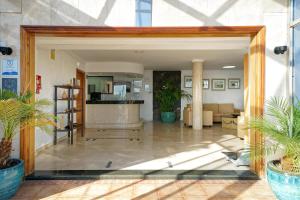 an open door into a lobby with potted plants at BLUESEA El Dorado in Puerto del Carmen