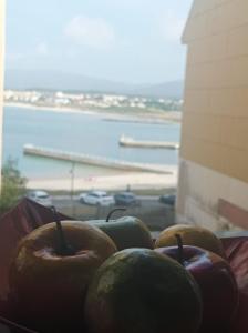 a group of apples sitting on a window sill at Apartamento A Rapadoira Foz in Foz