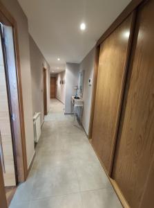 a corridor of a hospital hallway with a long hallway at Apartamento A Rapadoira Foz in Foz