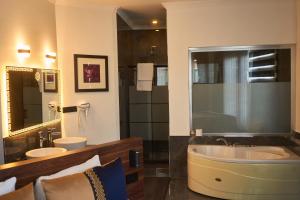 a bathroom with a large tub and two sinks at Seven Dreams Hotel in Istanbul