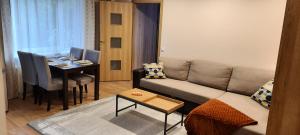 a living room with a couch and a dining room at Centrum Bridge Apartment in Pärnu