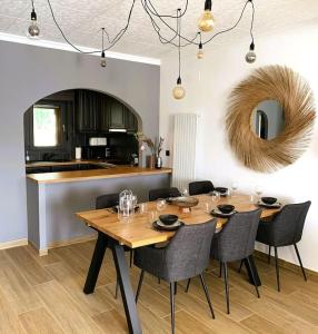 uma sala de jantar com mesa e cadeiras e uma cozinha em Casa Serenity au canal avec piscine et amarre em Empuriabrava