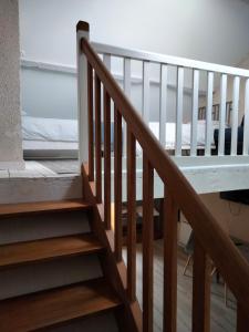 a wooden staircase leading up to a bedroom at La Brousse Kacha in Malleret-Boussac