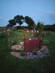 an old wagon sitting in the grass in a field at La Brousse Kacha in Malleret-Boussac