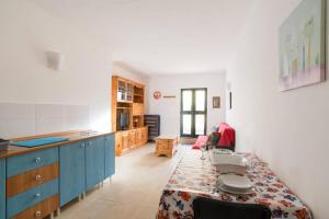 a kitchen with a table in the middle of a room at Spacious, modern apartment near beach andclose to st. Julians in Naxxar