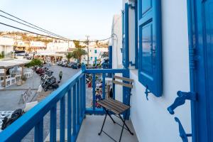 a blue balcony with a bench and a street at Liana sunset in Mýkonos City