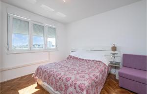 a bedroom with a bed and a purple chair at 1 Bedroom Lovely Apartment In Pula in Pula