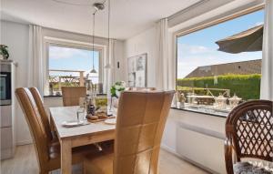 a dining room with a table and chairs and a window at Pet Friendly Home In Slagelse With House Sea View in Slagelse