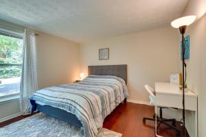 a bedroom with a bed and a desk and a window at Quiet Columbia Condo Near Parks and Pool! in Columbia