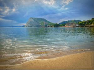 a body of water with a beach and a mountain at ATEA APARTMENT KAVARNA in Kavarna