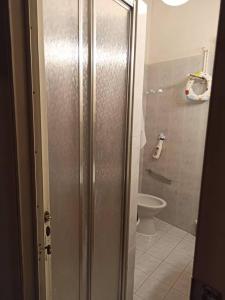 a bathroom with a toilet and a shower stall at Casa Santina in borgo medievale in Prata +82 photos