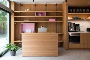 a kitchen with wooden cabinets and a counter top at Lisetta Gardens Boutique & Suites in Cisternino