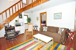 a living room with a couch and a table at River Valley Cabin - Riverfront Cabin in Morton Grove