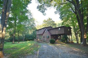 a house in the middle of a forest at River Time Cabin -Time floats away! in Berkeley Springs