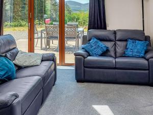 two couches and a couch in a living room at Cairn View in Strachan