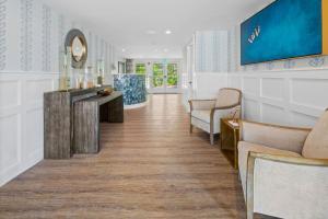a waiting room with couches and a mirror at Pelham on Earle in West Harwich