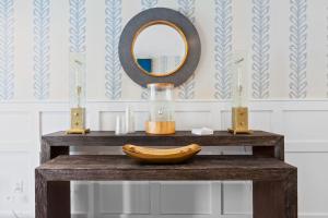 a wooden table with a banana and a mirror at Pelham on Earle in West Harwich