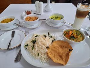 a table with a plate of rice and a bowl of food at Himalayan Sun Cottage in Srinagar +93 photos
