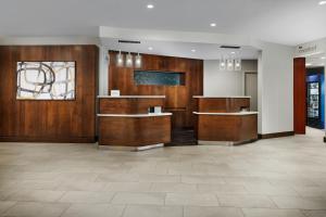 a lobby with wood paneled walls and a reception desk at Courtyard Manchester-Boston Regional Airport in Manchester