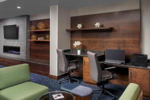 a lobby with a desk with a laptop on it at Courtyard Manchester-Boston Regional Airport in Manchester