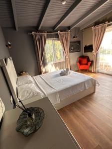 a bedroom with a bed and a table and a chair at Erythros Hotel in Çeşme