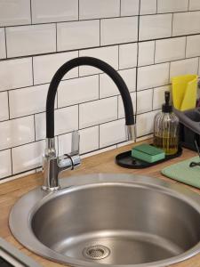a sink in a kitchen with a faucet at Quiet Center in Sremska Mitrovica
