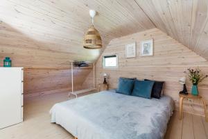 a bedroom with a bed in a wooden wall at Letnisko Lubiatowo in Lubiatowo