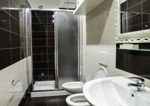 a bathroom with a sink and a toilet and a shower at Hotel Ristorante Termitito in Scanzano