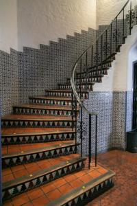 a spiral staircase in a building with a tile wall at Hotel Salta in Salta