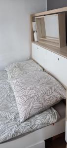 a bed in a small room with a drawer at Apartament Na Wydmie in Ustka