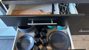 a drawer filled with dishes and utensils at Villa Männituka Suvetuba in Kirikuküla