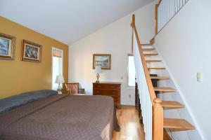 a bedroom with a bed and a spiral staircase at Home at Last - Gather here! in Berkeley Springs