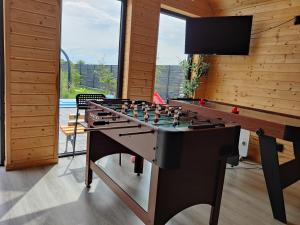 a game room with a foosball table and a tv at Osada Jantar-Resort&SPA in Jantar