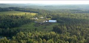 an aerial view of a farm in the middle of a forest at Moose Run #4 in Maynooth