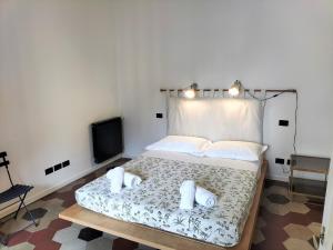 a bedroom with a bed with two towels on it at Donizetti Elegant Apartment in Florence