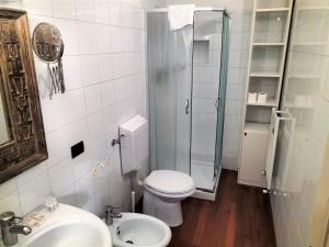 a bathroom with a toilet and a shower and a sink at Donizetti Elegant Apartment in Florence
