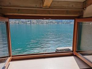 a view of the water from a window on a boat at Котор. Потрясающий вид. in Muo