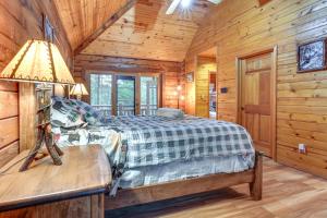 a bedroom with a bed in a wooden cabin at Magical Metamora Cottage with Fire Pit, Pond, Deck! in Metamora