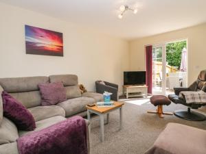 a living room with a couch and a table at Rolo's Retreat in Grange Over Sands