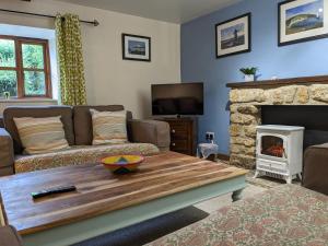 a living room with a couch and a fireplace at The Old Dairy in Bridport